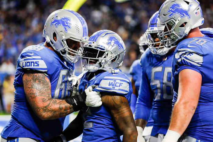 Detroit Free PressDetroit Lions running back D'Andre Swift, center, celebrates a touchdown with left tackle Taylor Decker, left, against the Washington Commanders during the second half at Ford Field.